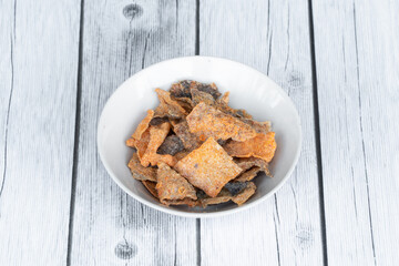 Thin crispy pork skin, used for snacking