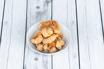 Thin crispy pork skin, used for snacking