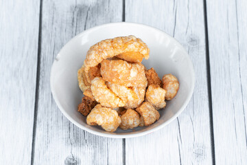 Thin crispy pork skin, used for snacking