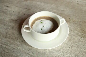 A delicious, steaming bowl of soup, artfully presented