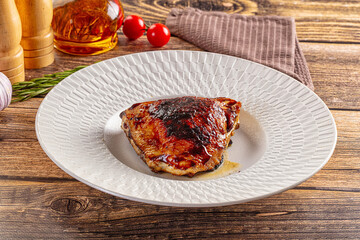 Roasted chicken thighs in the plate