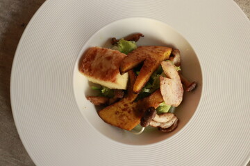 Gourmet salad featuring various ingredients. A culinary creation, artfully arranged on a plate, is ready to be enjoyed.
