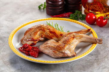 Roasted rabbit leg served rosemary