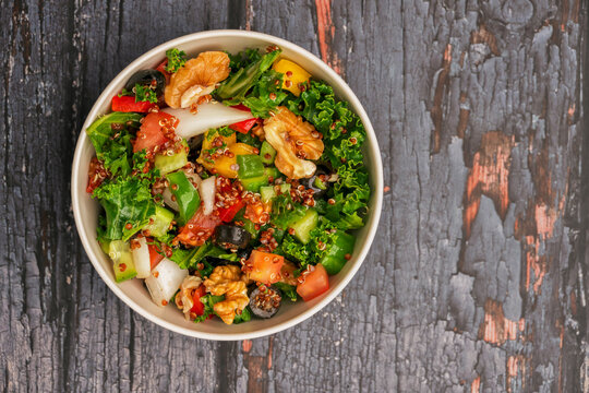 Fresh Quinoa Power salad with isolated wooden background. Breakfast power plate for healthy eating top view. Green healthy salad power plate eating. Vagan power bowl salad.