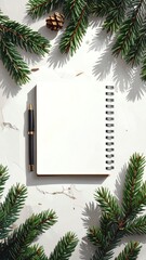 Blank notebook surrounded by green foliage.