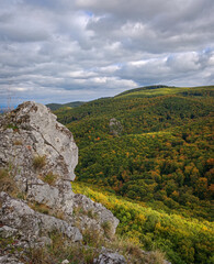 Limestone rocks on the slopes of Kemesnye Hill overlooking the forested ridges around Odvas-kő in the Bükk Mountains, Hungary.