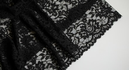 A close up shot of intricate black lace fabric on white surface , trending, fashion, lifestyle