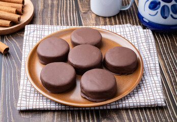 Brazilian Pao de Mel or chocolate covered honey cookies over a wooden table