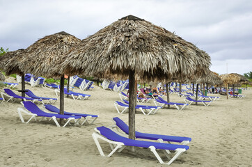 Beach chairs and huts in sandy beach