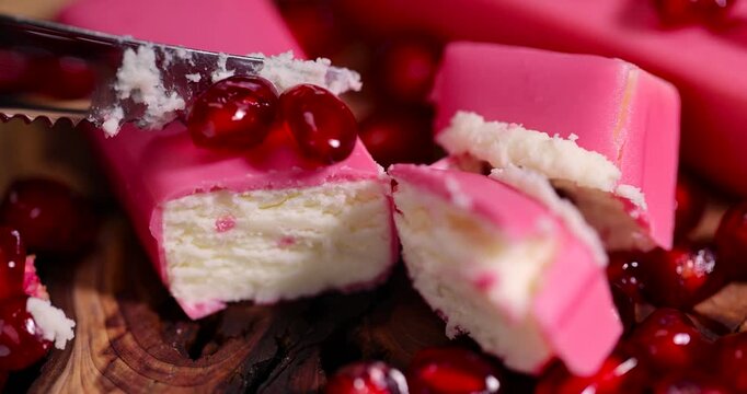 red ripe peeled pomegranate with large juicy grains and curd cheese in pink glaze, sweet red pomegranate seeds and curd sweet products