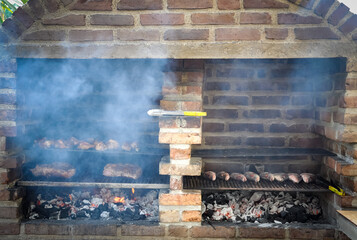 Grilling meat and fish in old brick wall oven