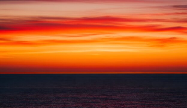 Dramatic sunset over the ocean vibrant colors fill the sky creating a serene and peaceful seascape