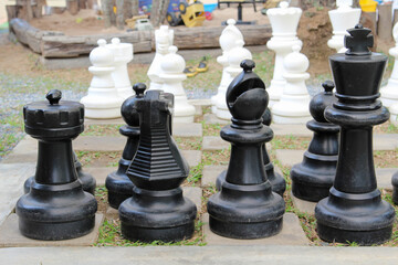 A giant outdoor chess set on green grass