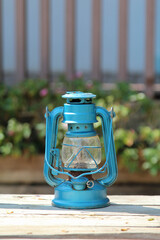 A blue old vintage lamp on a old wooden crate