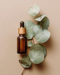 Amber glass dropper bottle rests beside natural green foliage on a neutral background