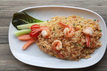 Delicious plate of fried rice with shrimp and fresh vegetables