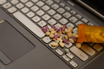 Online Pharmacy Concept with Prescription Medication on Laptop Keyboard