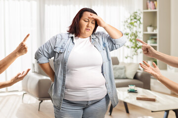 People reprimending overweight woman