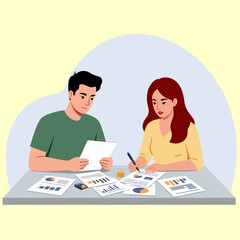 Fototapeta premium Two individuals, a man and a woman, are seated at a table, reviewing financial documents. The woman is writing with a pen. Several reports and charts are visible