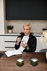 Young man engages with his smartphone while enjoying a cozy moment at home