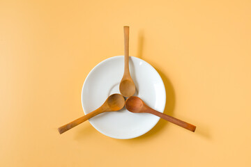 Wood spoons on  white plate