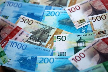 Norwegian Krone currency money bills. NOK currency banknotes in stack with different denomination close up