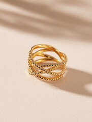 Intricate golden finger adornment features multiple crossing bands with detailed beading