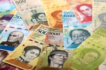 Venezuelan Bolivar currency money bills in big amount. Heap of VED currency banknotes with different denomination close up