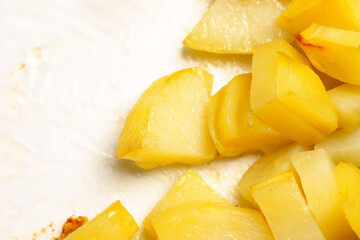 Fried potato slices in a glass container close up
