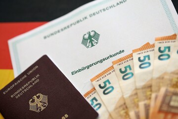 German passport on an official naturalization certificate. Symbolic for successful acquisition of German citizenship close up