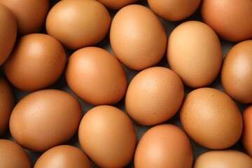 Many raw chicken eggs on table, top view