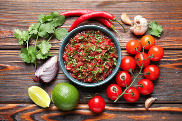 Tasty salsa sauce and ingredients on wooden table, flat lay