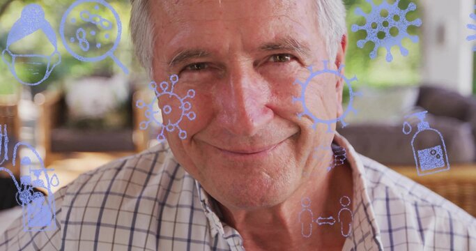 Sitting senior man in checkered shirt on patio, overlaying virus, magnifier, soap, distancing icons - Powered by Adobe