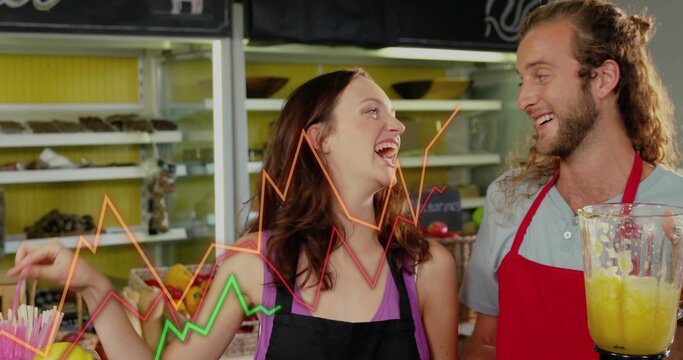 Smiling baristas wearing aprons blending smoothie and displaying graphs at juice bar with straws - Powered by Adobe