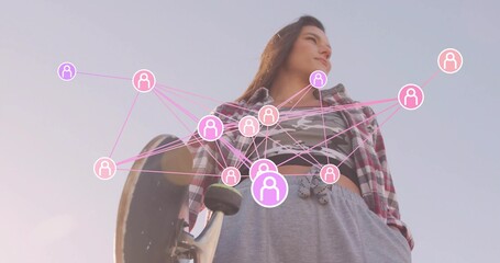 Woman wearing plaid shirt and camo top gripping skateboard in open area, with network icons overlay