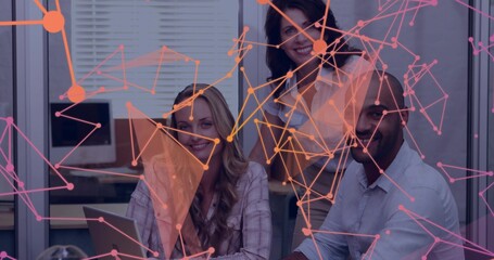 Discussing three staff in business attire using laptop and monitor in office, with network overlay