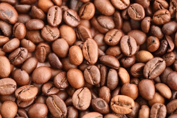 Textured background of freshly roasted coffee beans close up