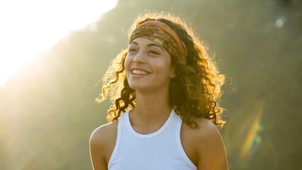 Smiling Woman in Natural Light Headband and White Tank Top