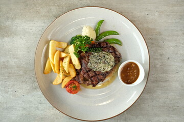 A delicious plated steak with side dishes, a culinary delight