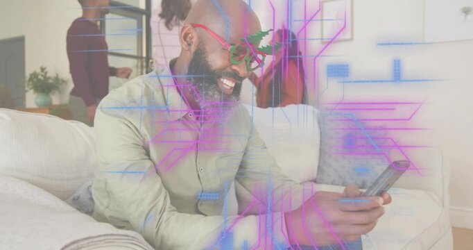 Man tapping phone initiating social media call to send holiday greeting as family decorating tree