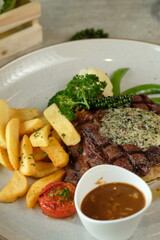 Delicious steak with sides and sauce, a culinary masterpiece!