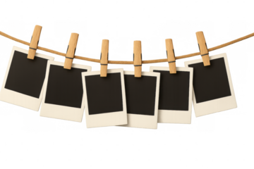 Blank vintage instant print film frames hanging on a rope with clothespins, transparent background
