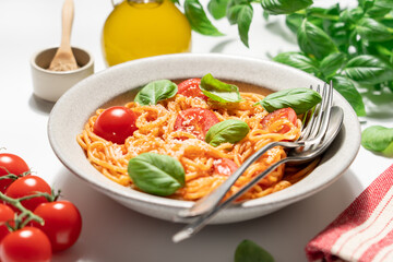 Delicious spaghetti with tomato sauce, cherry tomatoes, parmesan cheese and fresh basil on light background, Italian pasta dish top view