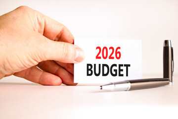 2026 Budget symbol. Concept words 2026 Budget on beautiful white card. Beautiful white paper background. Businessman's hand. Business and 2026 budget concept. Copy space.