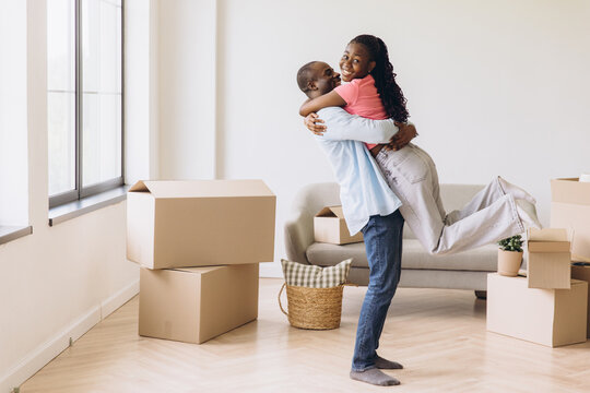 African American couple embracing celebrating moving day new home