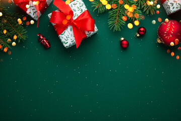 Christmas background with xmas tree, decorations, gifts, presents and sparkle bokeh lights on green background. Merry Christmas greeting card. Winter holiday theme. Happy New Year. Space for text	
