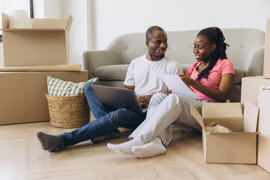 African couple planning new home move - Powered by Adobe