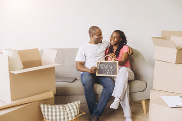 African couple celebrating moving day in new home