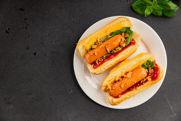 Hotdog fried onions, sausage, bun, sauce fast food tasty snack fresh delicious gourmet food background on the table rustic top view copy space