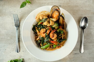 A close-up shot of a gourmet seafood pasta dish with a vibrant array of colors, expertly plated and ready to be enjoyed